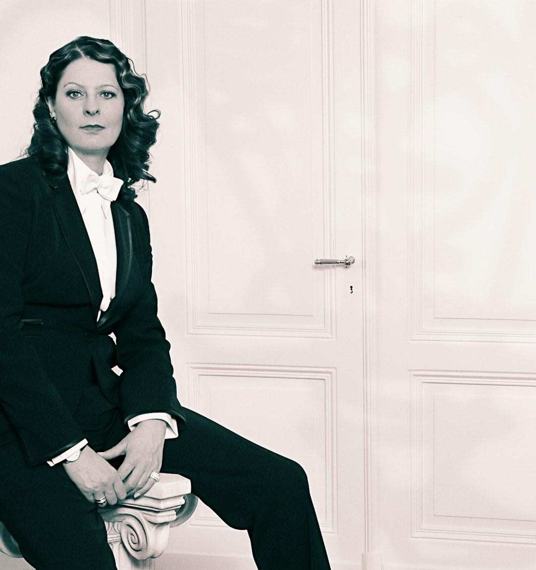 Portrait of a distinguished European woman in her 50s in a formal blazer