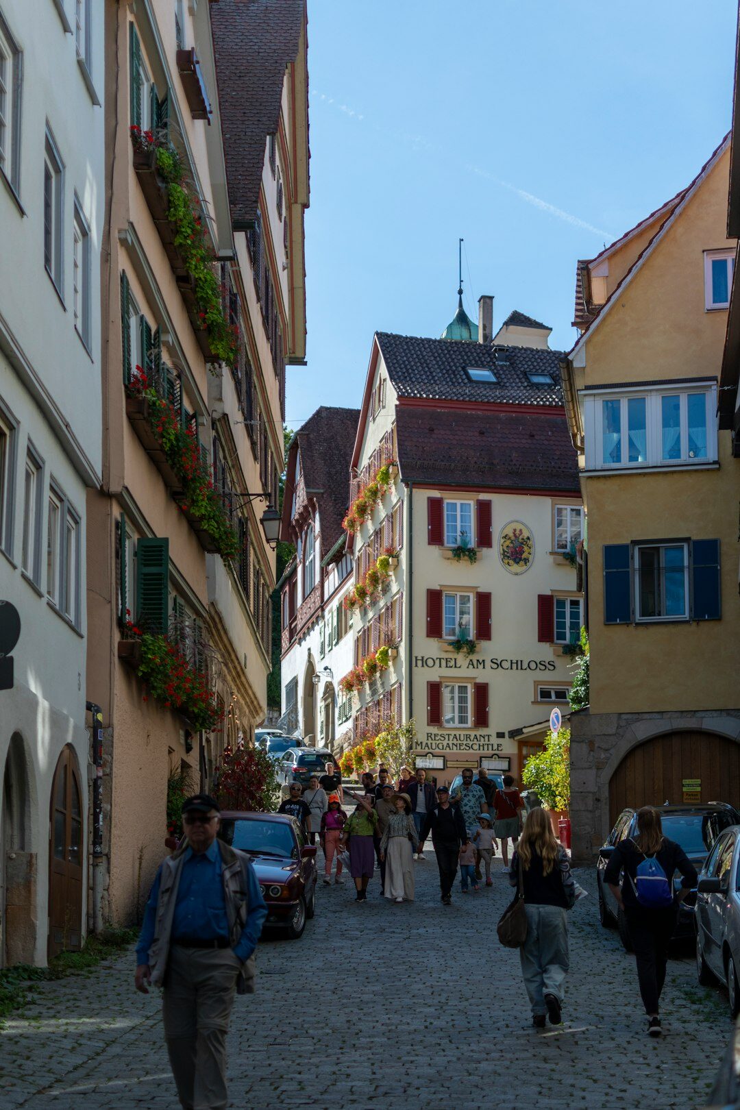 Charming cobblestone street in a historic Swiss old town with flower boxes