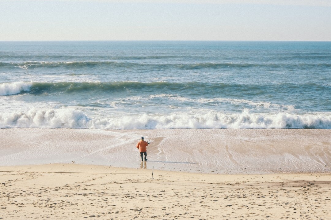celebrity walking on quiet beach